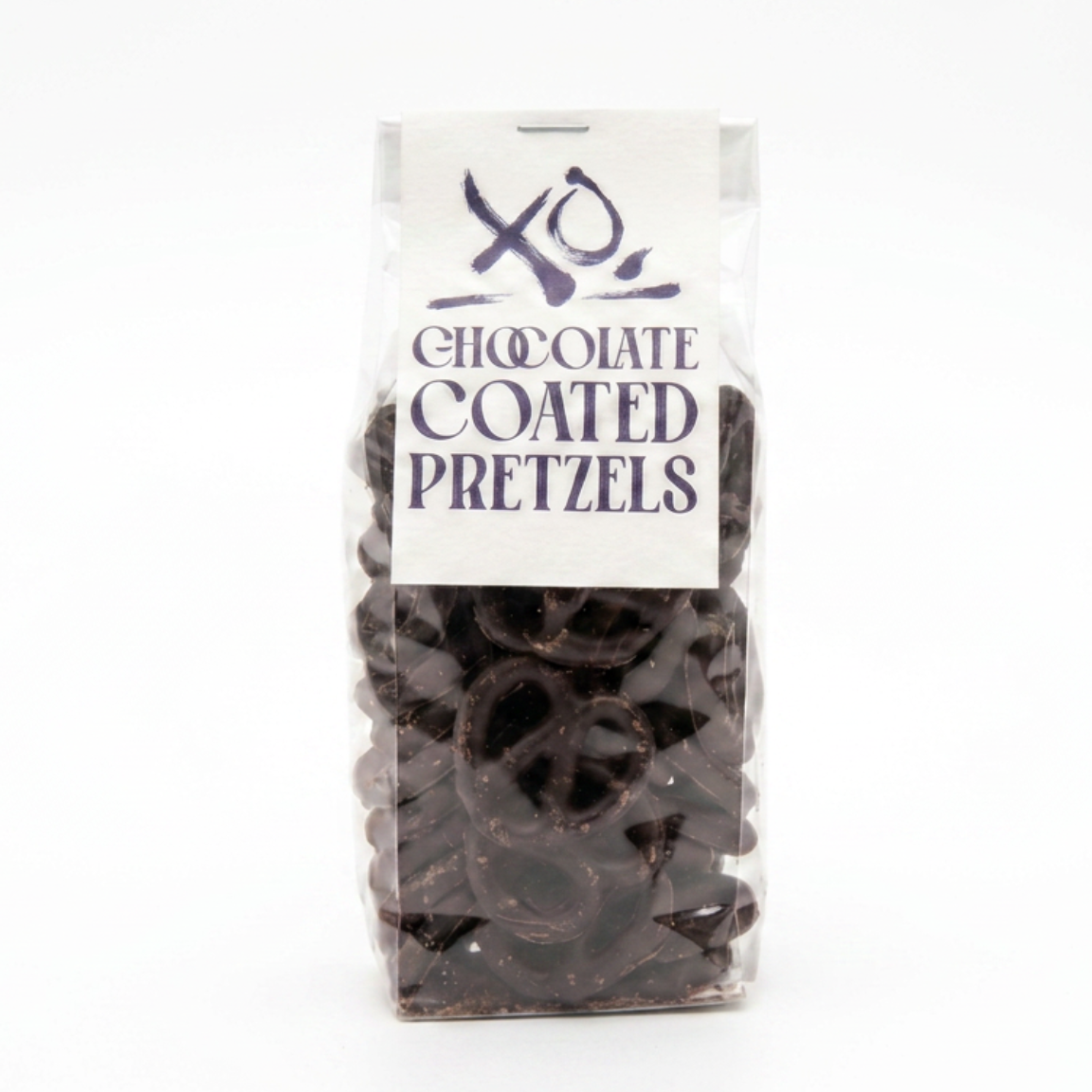 A bag of dark chocolate coated pretzels with a white paper label on a plain white background.
