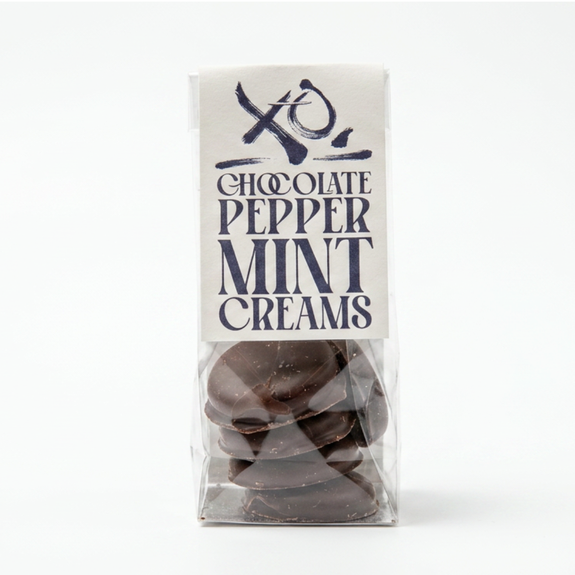 A bag of chocolate peppermint mint creams with a white XO CHOCOLATE paper label on a plain white background.