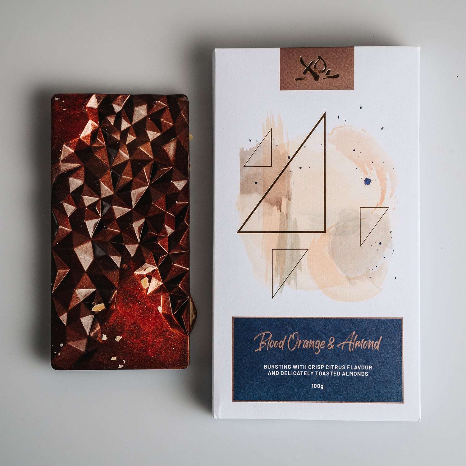 Blood Orange and Almond Bar by XOChocolate, featuring zesty citrus and crunchy nuts in dark chocolate.