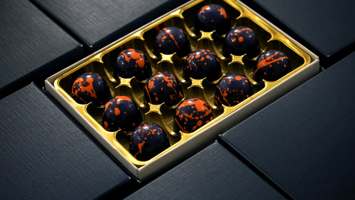 12 Popping Candy milk chocolate bonbons with hazelnut praline by XO Chocolate London